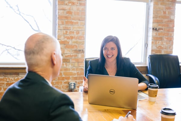 woman-and-man-sitting-at-table-doing-job-interview