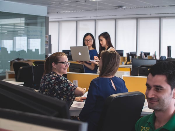 people-sharing-computers-in-an-office